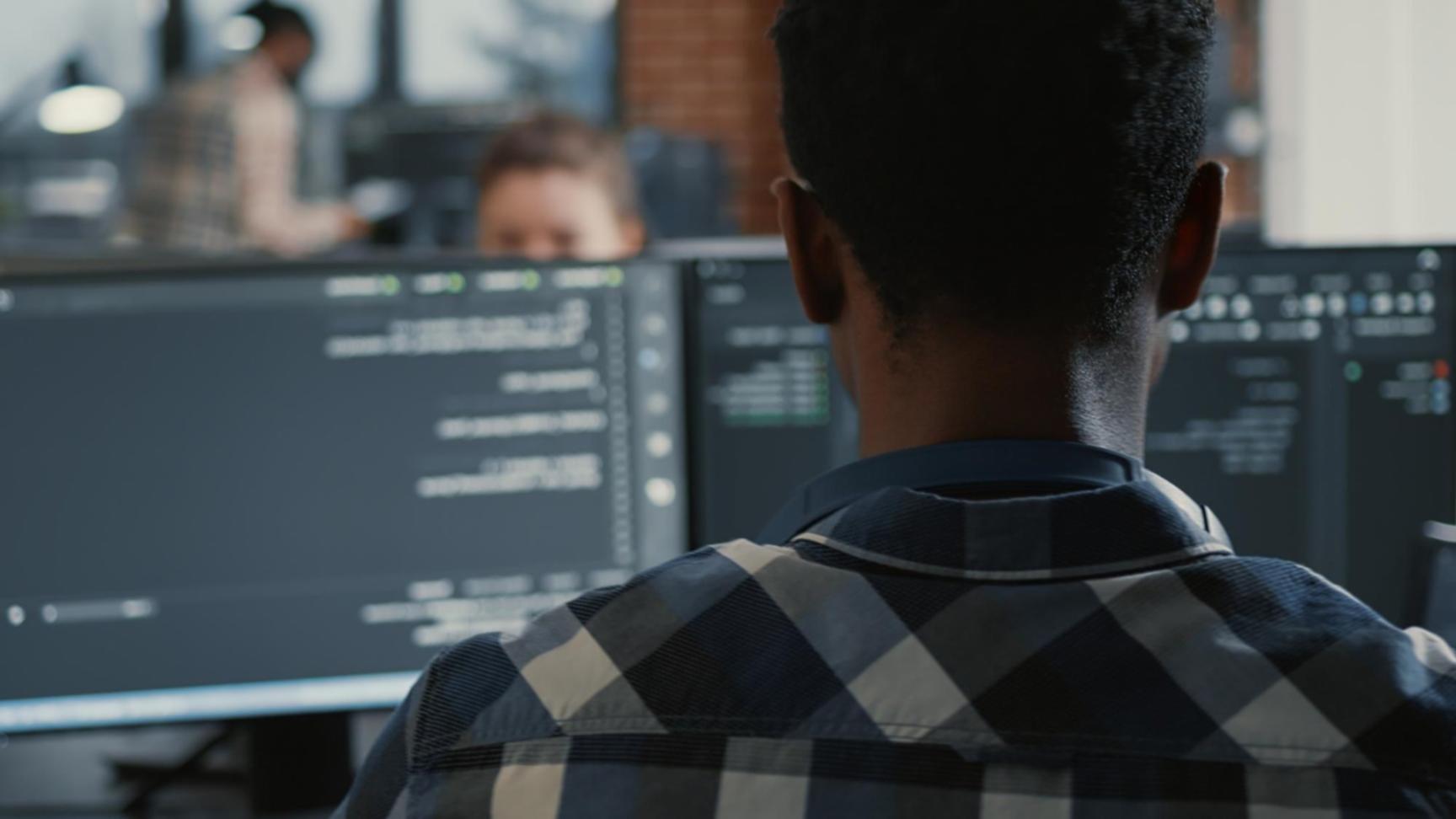 Modern workspace showing collaborative app development environment with multiple devices
