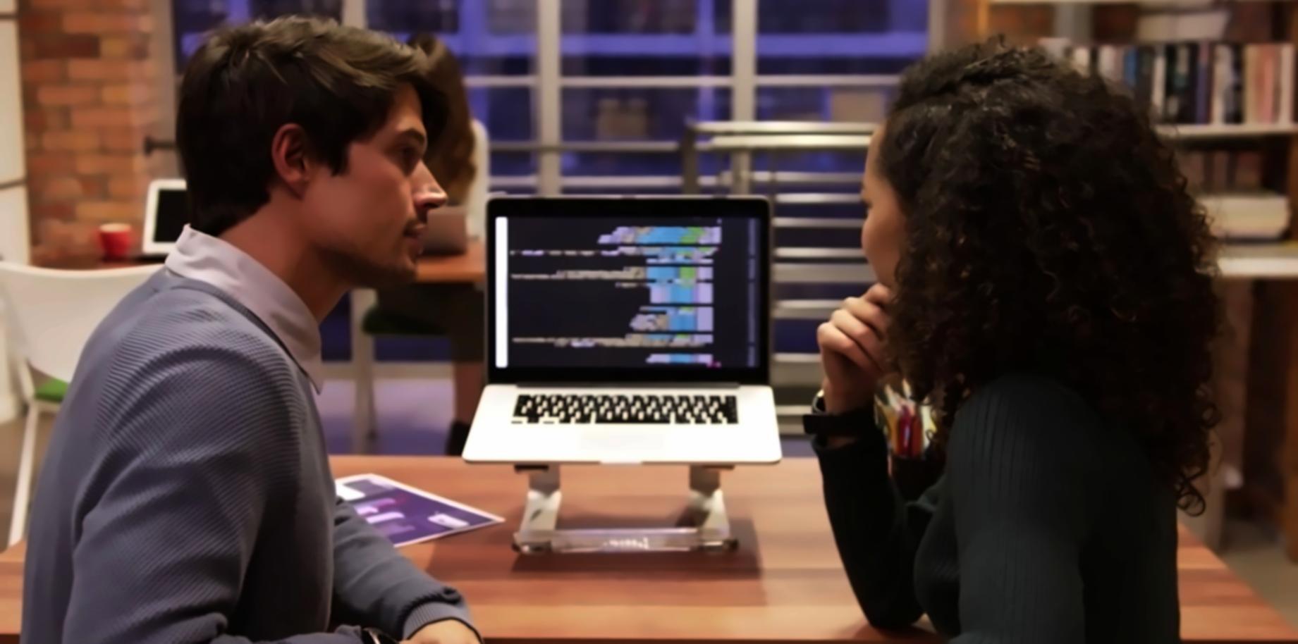 Students working on mobile app projects in development environment